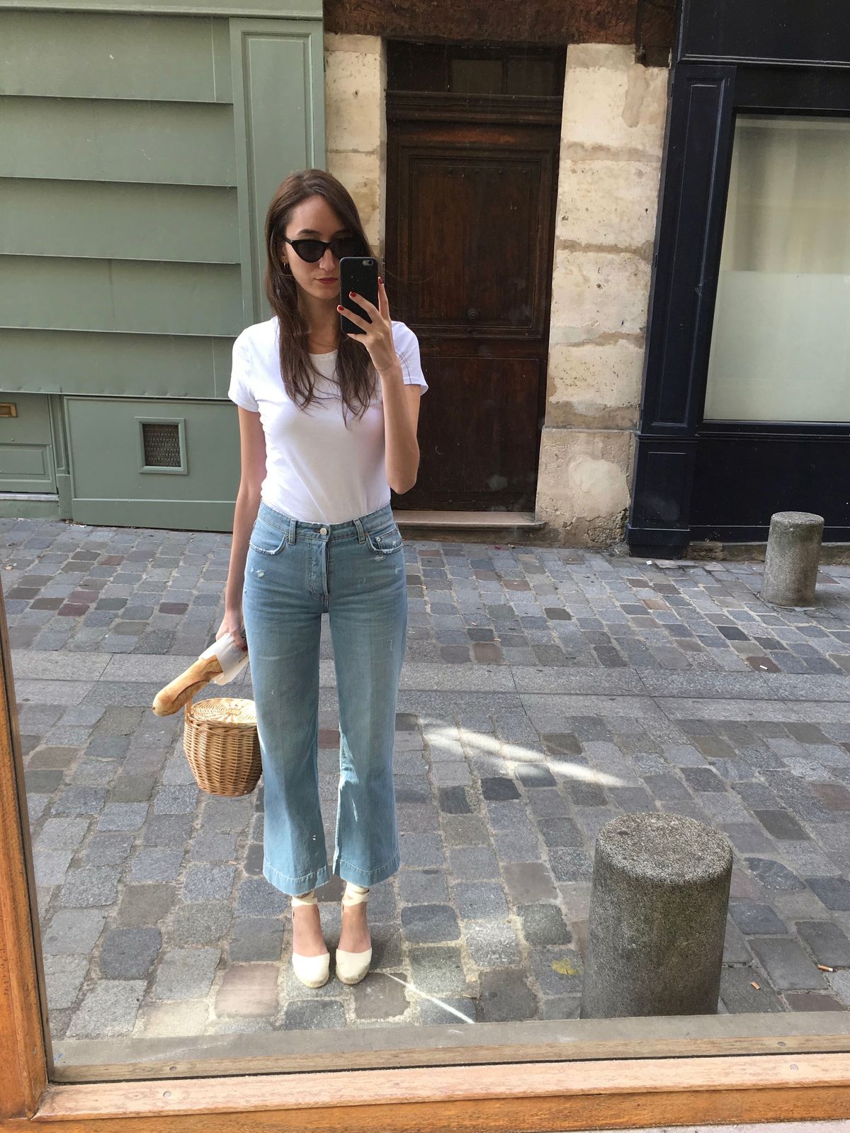French Girl Accessories - basic white t-shirt, wide leg jeans, Birkin basket bag, Castaner espadrilles, black cat-eye sunglasses and a baguette