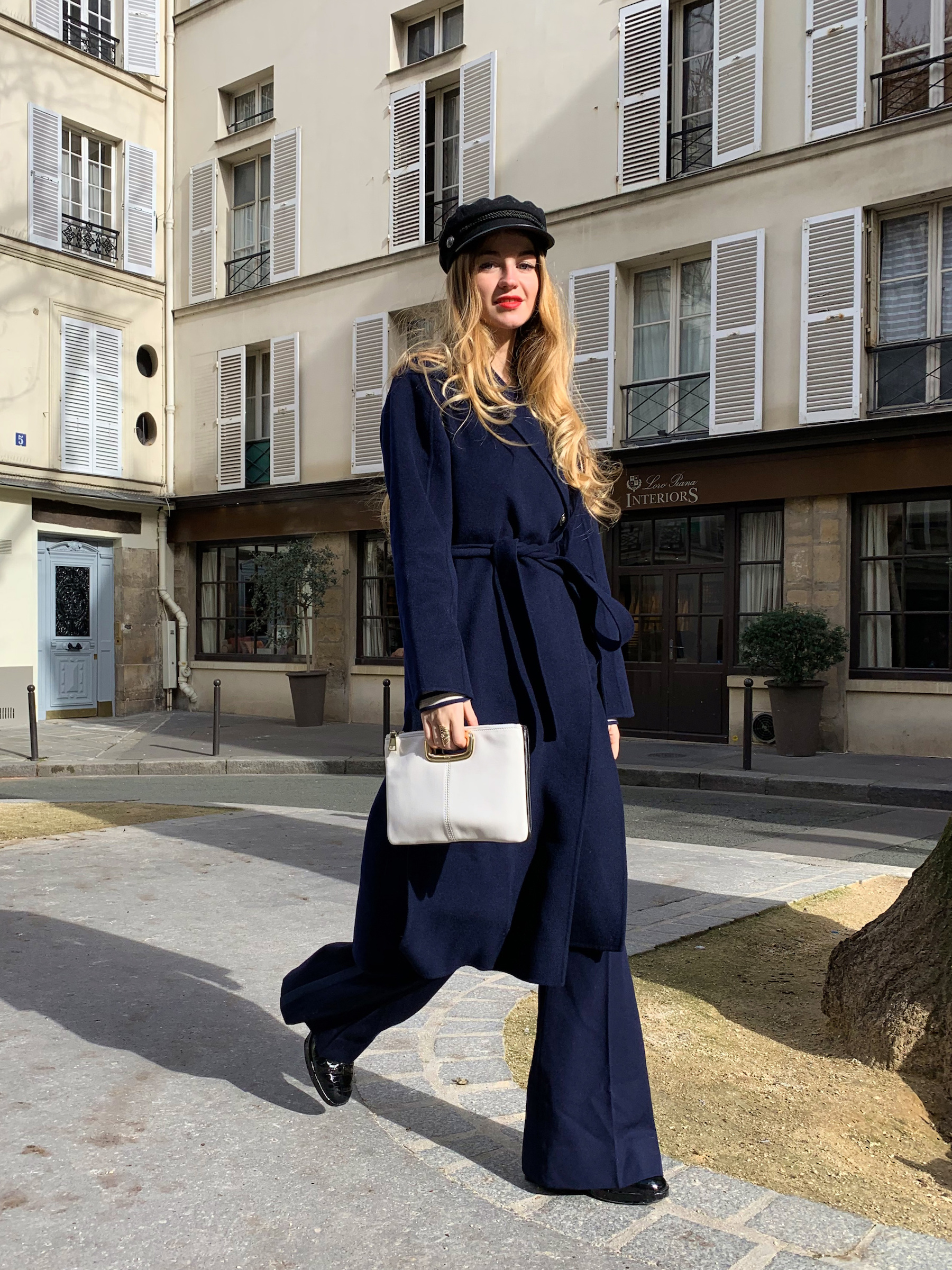 Constance Arnoult wearing a long navy wool wrap coat