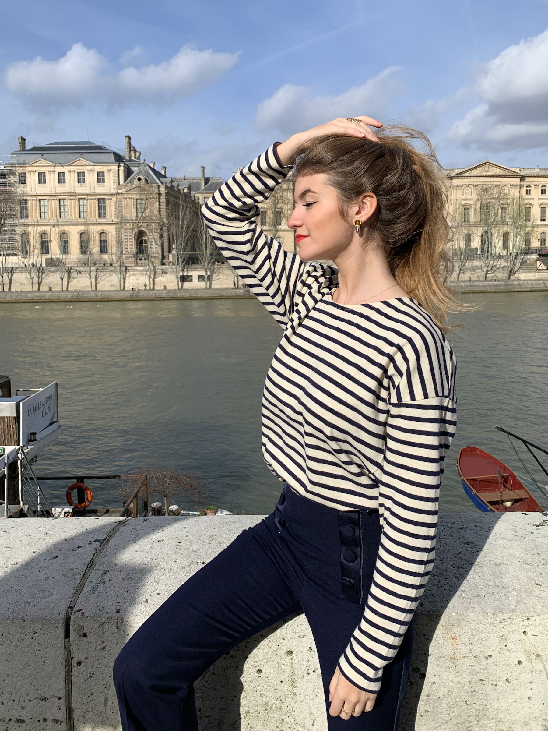 Constance Arnoult wearing a marinière top on the banks of the Seine River