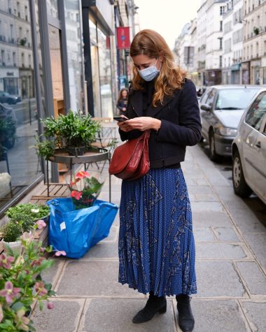 French style - a woman wearing a blue pleated skirt by Caroll in Paris, France during the lockdown